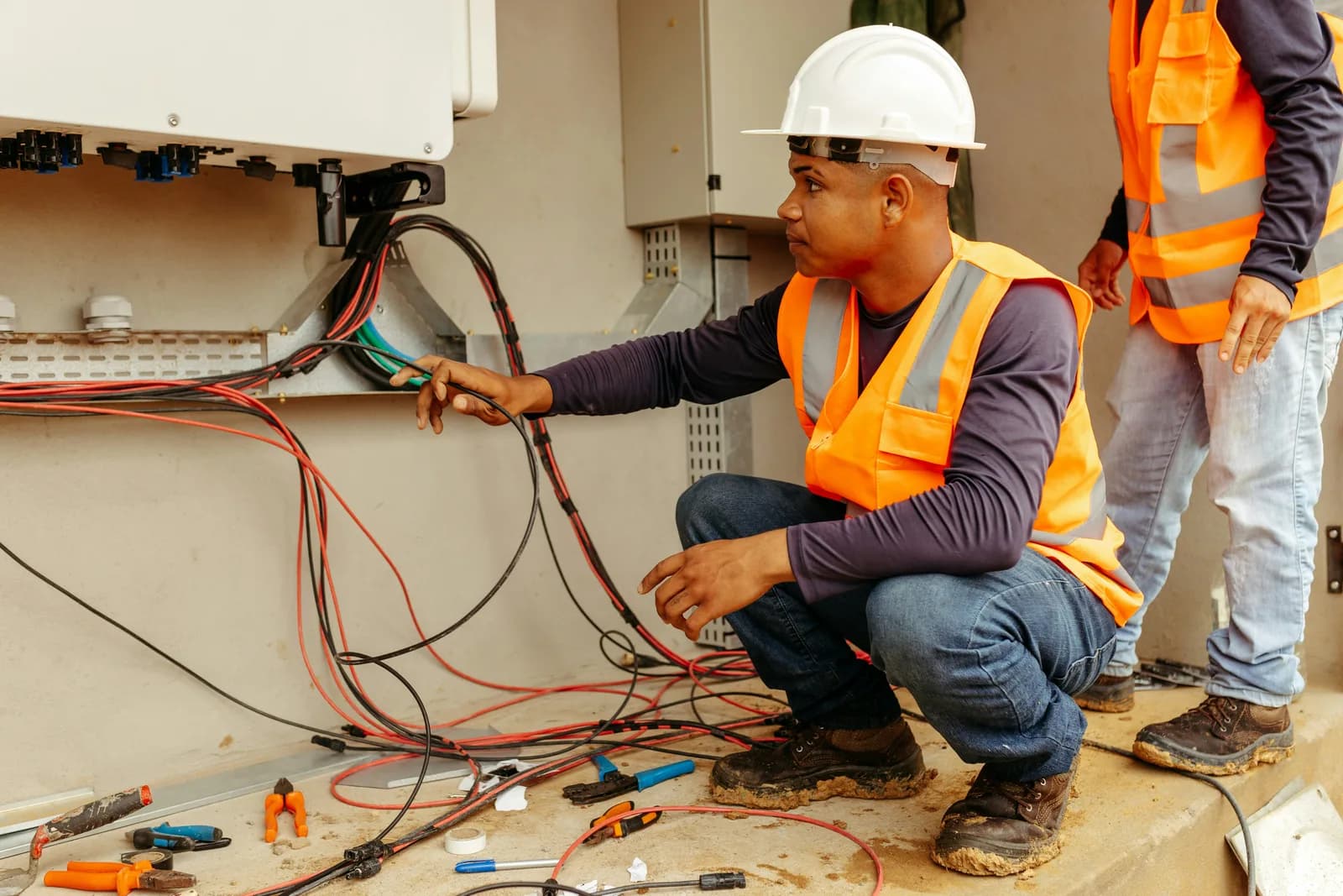 Solar installer routing electrical cables